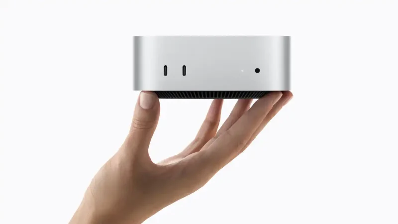 new Mac Mini Someone holding the new Mac mini